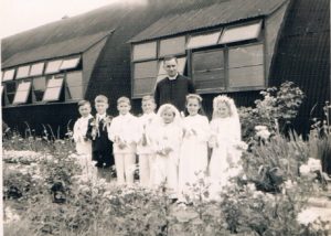 Bogdan Latyszonek far left, Father Marcin Bardel behind. First Holy Communion - perhaps with Hostel chapel behind.