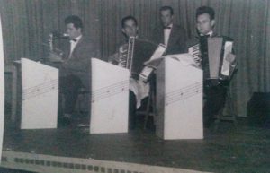 Edward playing the accordion in a band