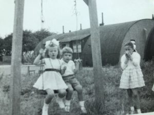 Elizabeth Oleszkiewicz and Mieczyslaw (Michael) Wesolowski on the swing at site 3 with Melania (Mela) Jeron