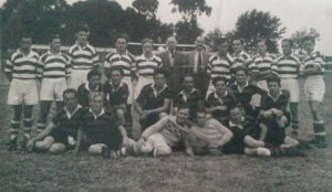 A photo of a football team. Edward is 2nd from right in the middle row