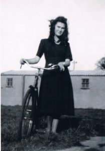 Genia Sokolowska with her first bicycle in front of camp toilets - 1952