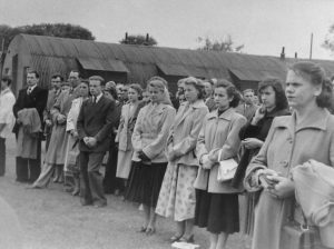 Ted (in front with hands clasped) probably at a religious ceremony, most likely Corpus Christi or a funeral.